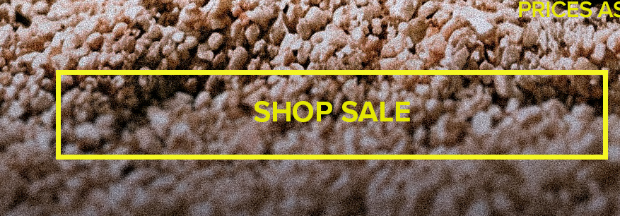 Yellow SHOP SALE promotional button over textured brown gravel, directing users to discounted collections with earthy background tones.