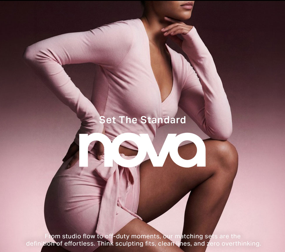 Confident woman in pink nova loungewear matching set, long-sleeve top & shorts, for effortless style and sculpting fit.