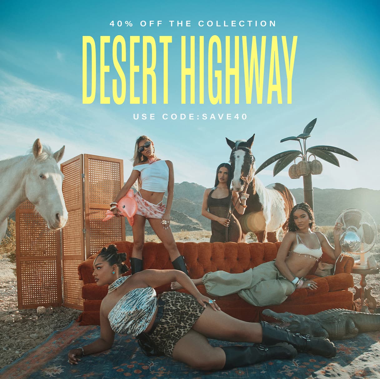 Women in stylish desert apparel pose with horses and an orange couch in a desert landscape, promoting the 40% off Desert Highway collection sale.