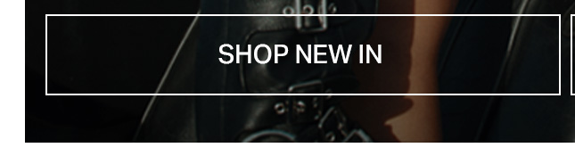 Dark, close-up view of a person wearing black leather clothing with metallic buckles and straps, partially revealing skin. Discover new fashion arrivals for an edgy style.