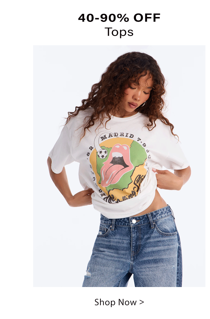 Woman in white Rolling Stones Madrid graphic t-shirt & blue jeans. Shop women's tops up to 90% off!
