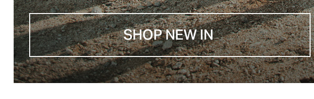 Rough beige and brown ground texture, casting long shadows. A clear "SHOP NEW IN" button prompts discovery of our latest collection and new arrivals.