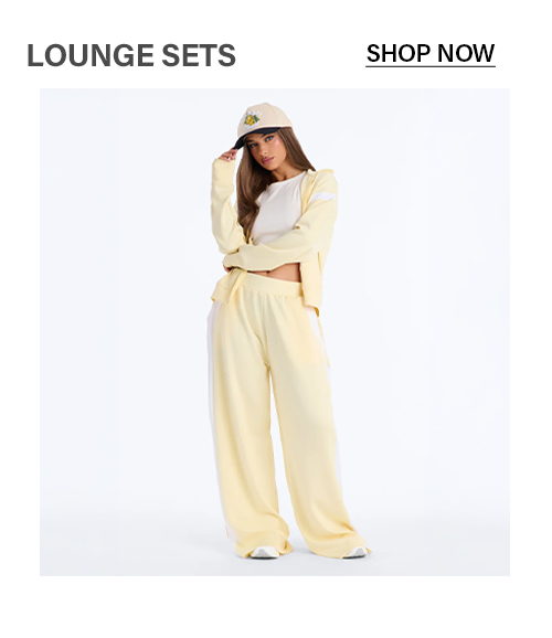 Stylish yellow women's lounge set: cropped hoodie, wide-leg sweatpants with white stripes, white crop top. Perfect for comfy casual wear.