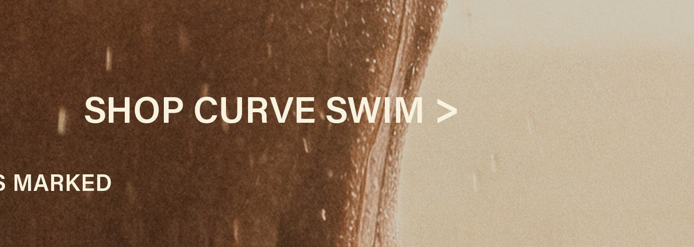 Close-up of a wet, curved body in rich brown tones with water droplets. Light beige background. Text "SHOP CURVE SWIM" to explore plus size swimwear.