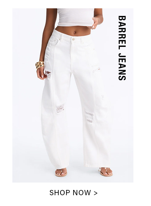 Person modeling white distressed barrel jeans with a white crop top and gold bracelets, promoting the women's barrel jeans collection. Shop Now