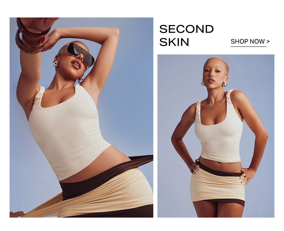 Model wearing a cream tank top and mini skirt from the Second Skin collection campaign, set against a blue background with a shop now button.