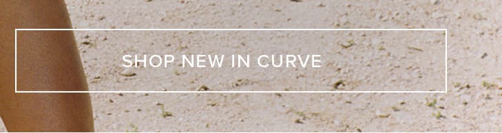 Close-up of tanned skin and sandy texture, featuring "SHOP NEW IN CURVE" in a white box. Explore new arrivals in curve sizing.