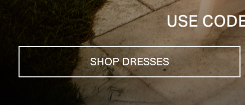 White-bordered 'Shop Dresses' button with white text, against dark grass and light paving. Use code to browse new dress arrivals and styles.