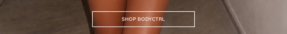 Tanned legs on grey floor. White 'SHOP BODYCTRL' button promotes versatile body control and activewear collection.