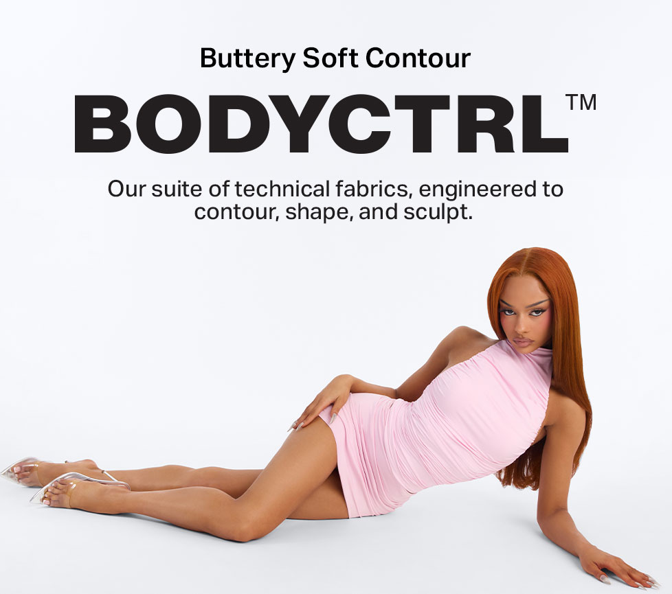 BODYCTRL™ Buttery Soft Contour pink ruched mini dress on a woman. Technical fabric designed to shape and sculpt for a flattering look.