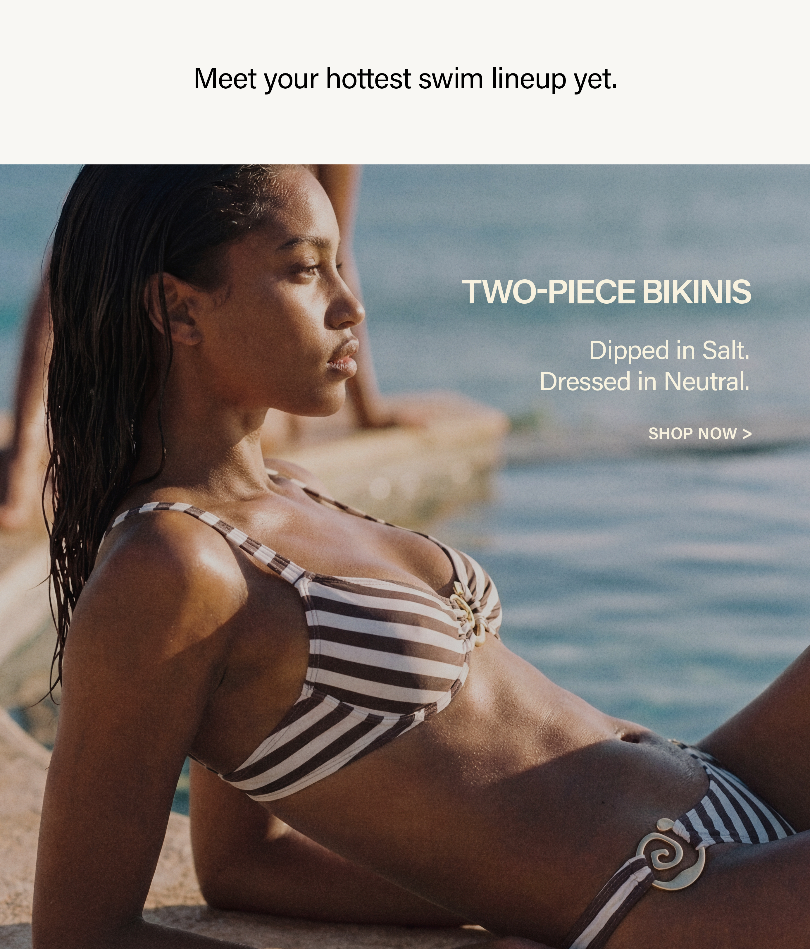 Woman in a chic striped brown and cream two-piece bikini, lounging by the water. Discover our new neutral swimwear collection.