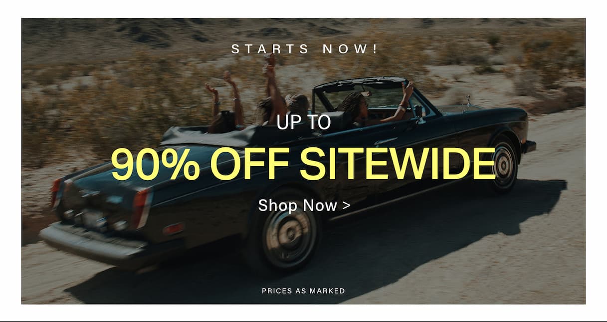 Dark convertible car with excited people driving on a desert road, announcing a sitewide discount sale: up to 90% off fashion.