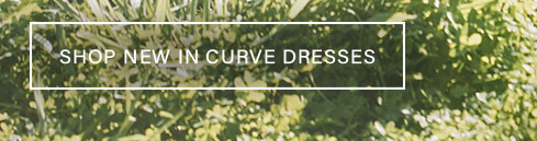 White text 'SHOP NEW IN CURVE DRESSES' on a rectangle, overlaid on a lush green foliage background, encouraging users to browse new curve dresses.