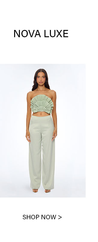 Nova Luxe model showcasing a chic light green two-piece outfit: pleated strapless crop top and flowing wide-leg pants. Shop now.