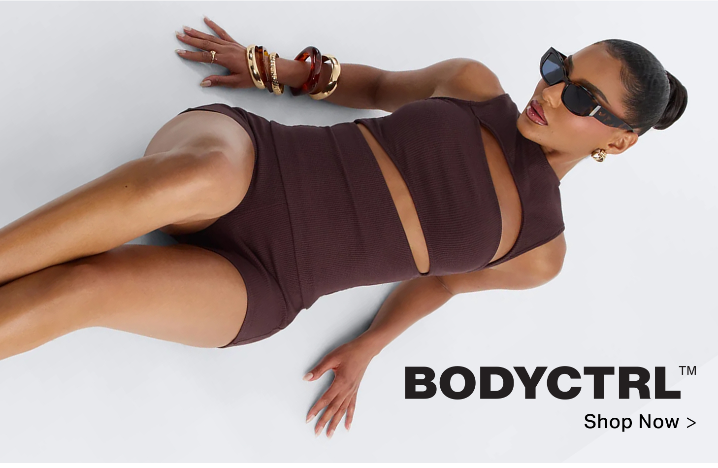 BODYCTRL woman in a dark brown ribbed cutout romper, sunglasses & bangles. Shop now for trendy women's fashion.