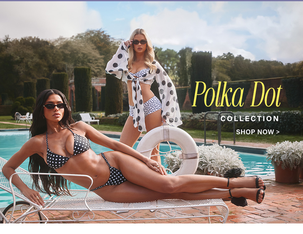 Two women in chic black and white polka dot bikinis poolside, one reclining. Shop our stunning new polka dot swimwear collection now!