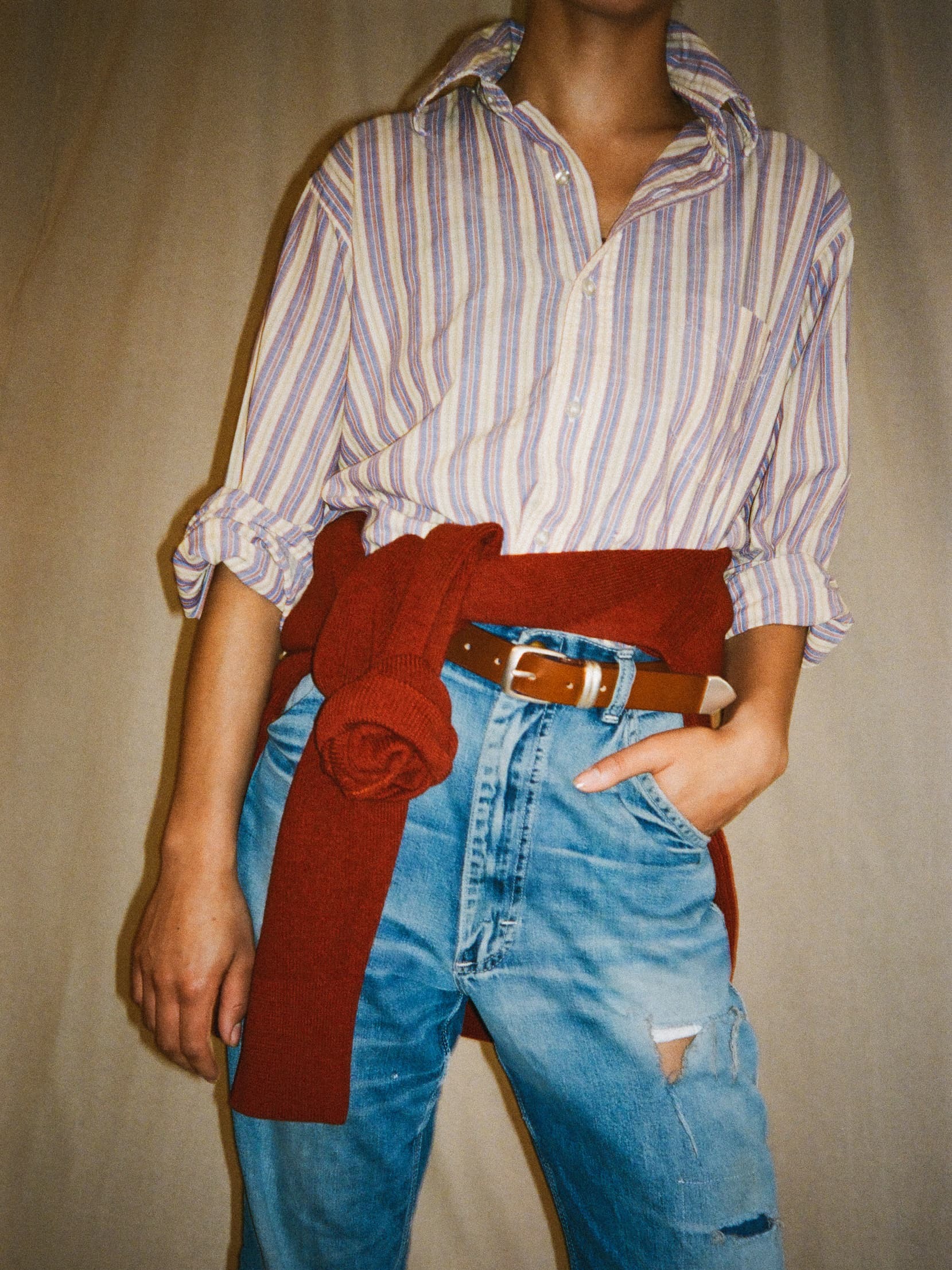 an image of a stack of four belts with a white buckle