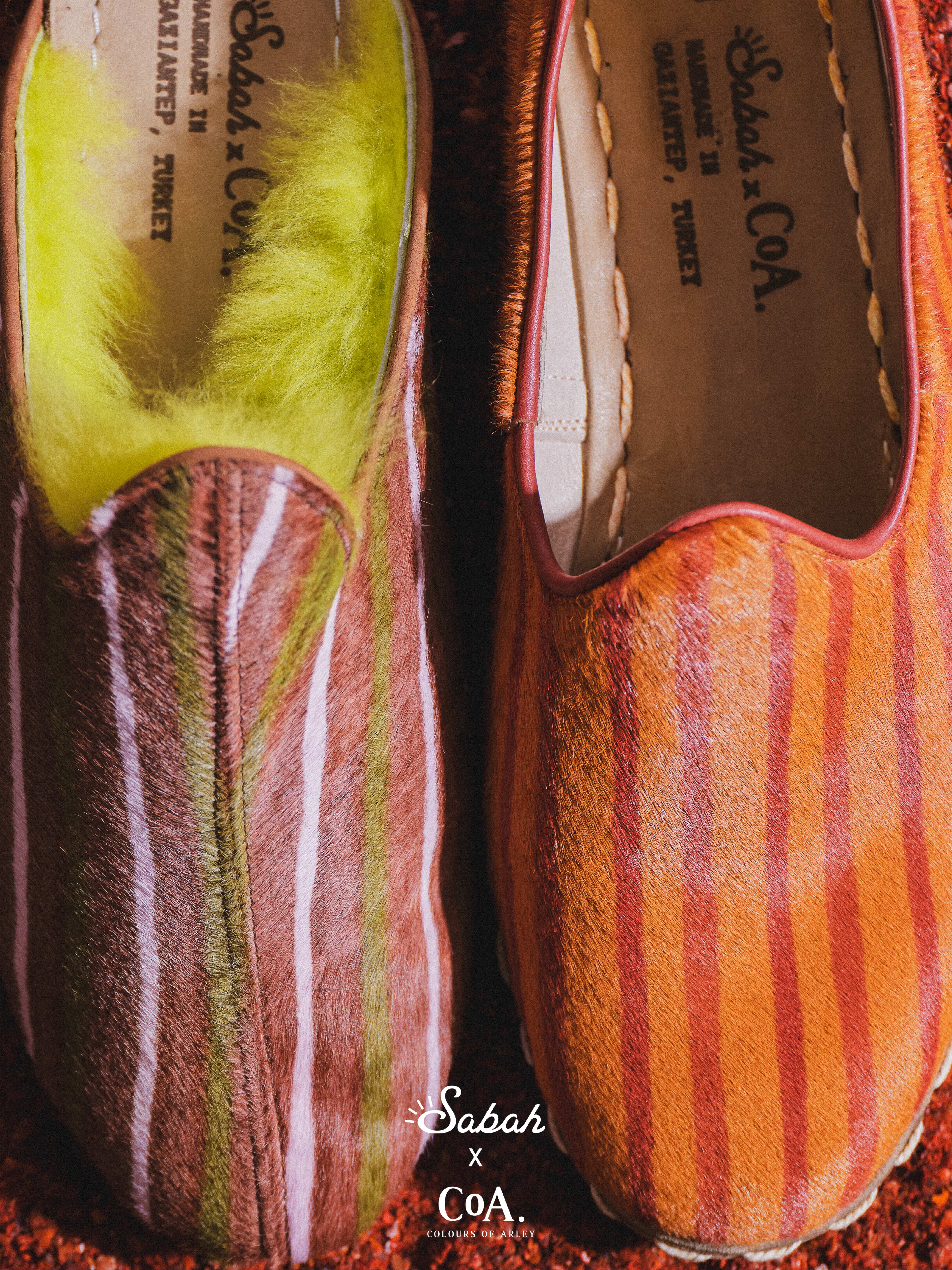 an image of a stack of four belts with a white buckle