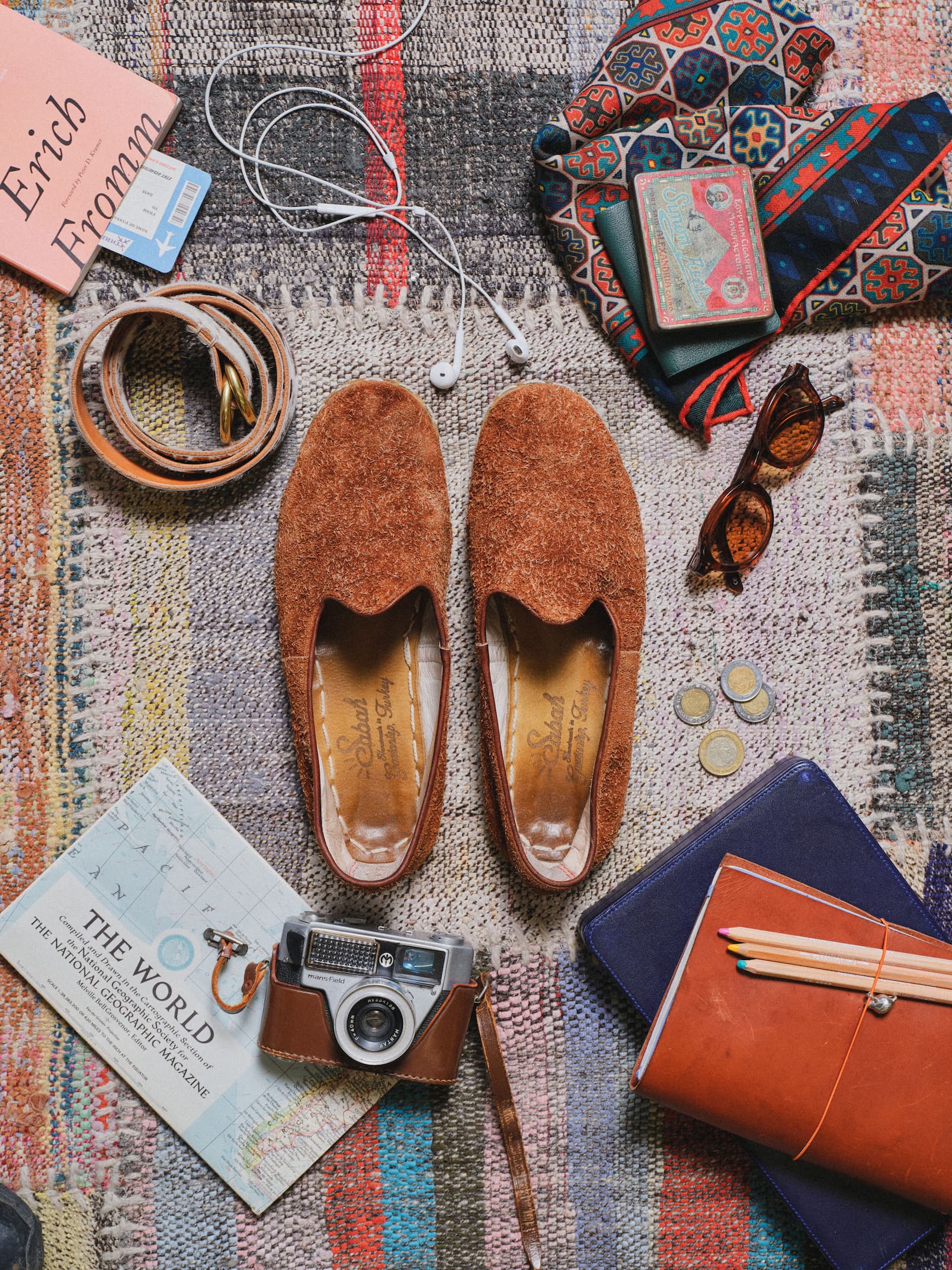 an image of a stack of four belts with a white buckle