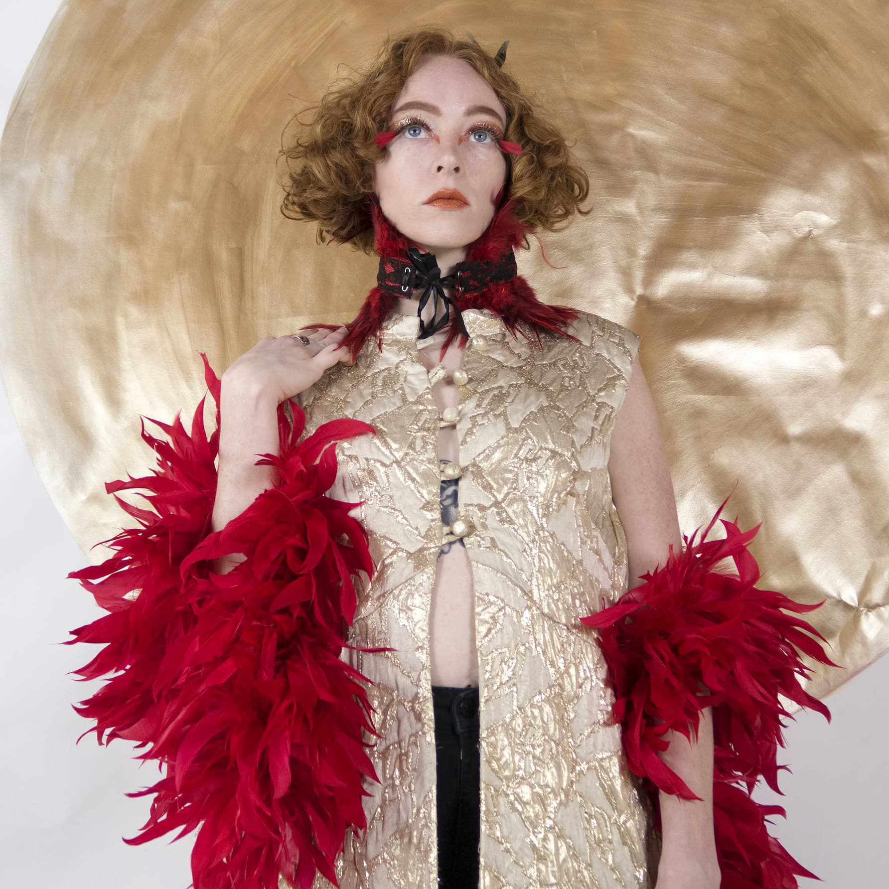 Red feather boa layered over Halloween costume