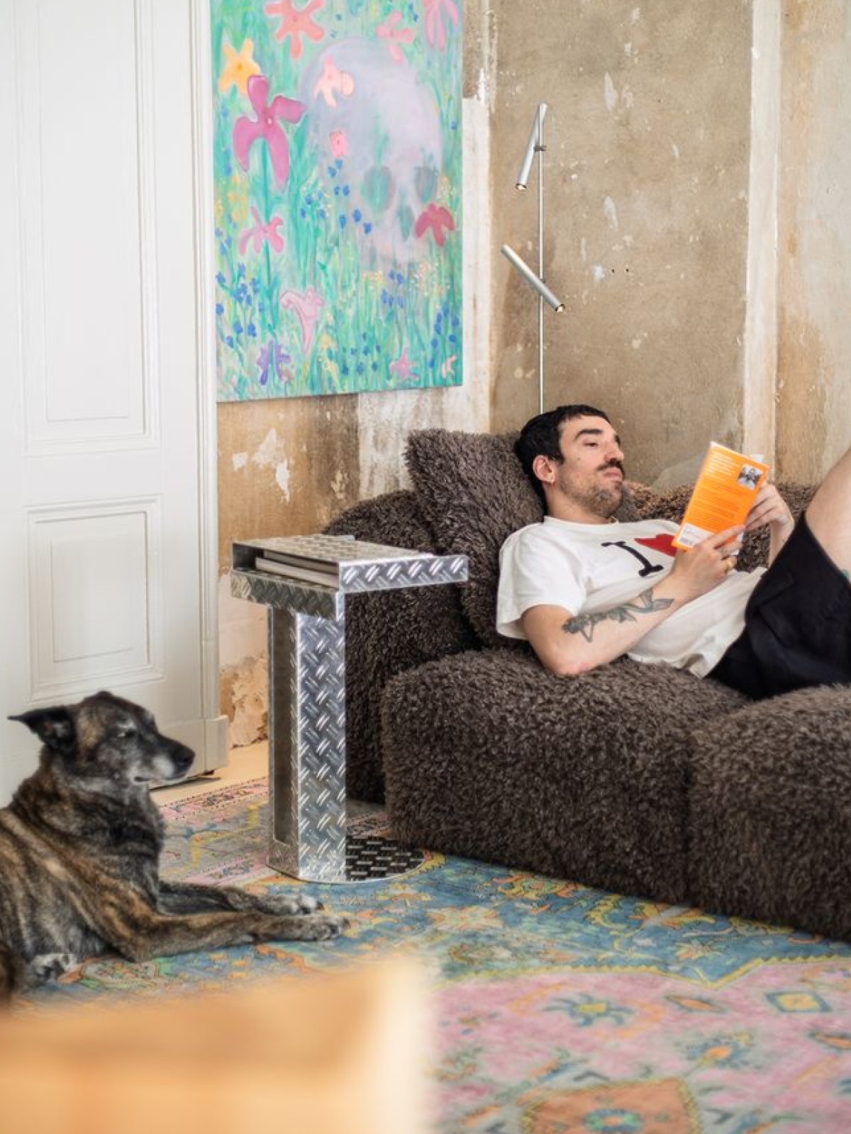 Guy unwinds with a good book with Frecha the dog