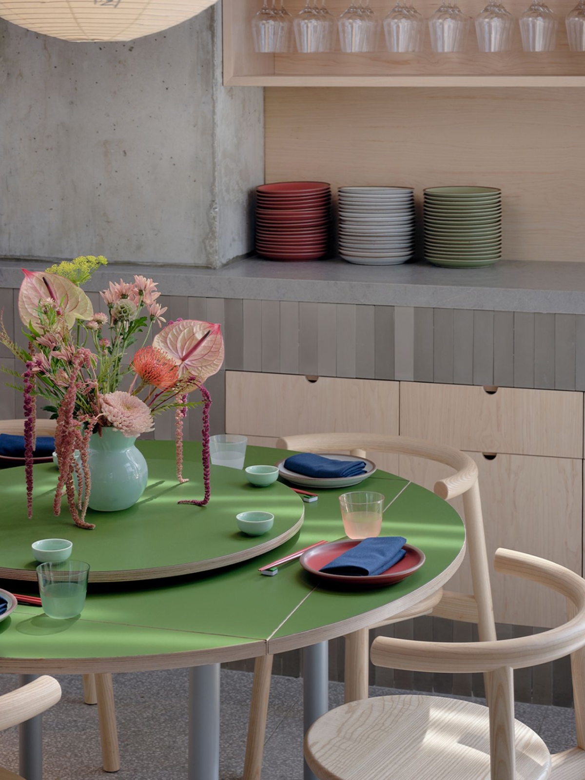 Table set with green tabletop and floral centerpiece
