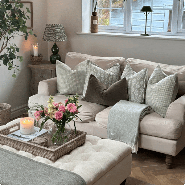 Styled by @our_wandsworth_home, our sage-toned cushions and throws introduce a gentle wash of colour softening the sofa and bringing balance to the living room.