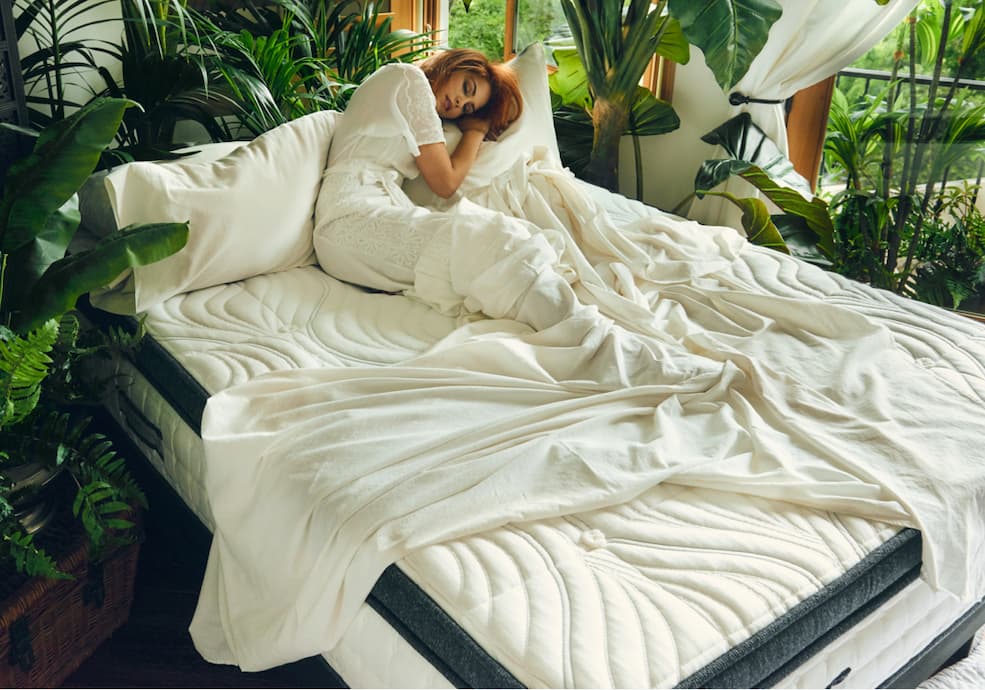 Women sleeping on the Oceano Mattress surrounded by plants.