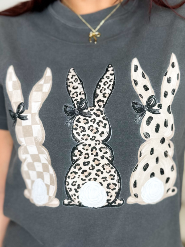 an image of a woman wearing a gray shirt with three bunnies on it