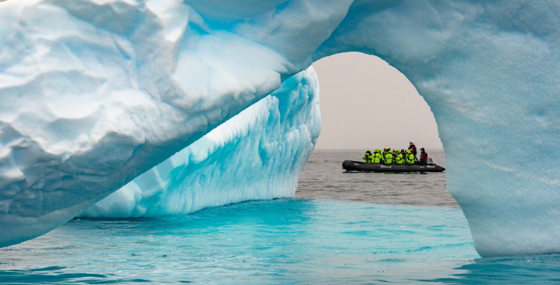 Atlas explorers on a Zodiac safari navigating glaciers in Antarctica