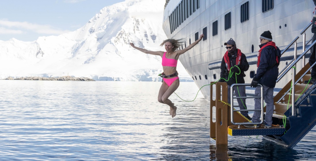 An Atlas Explorer taking the polar plunge from the yacht in Antarctica