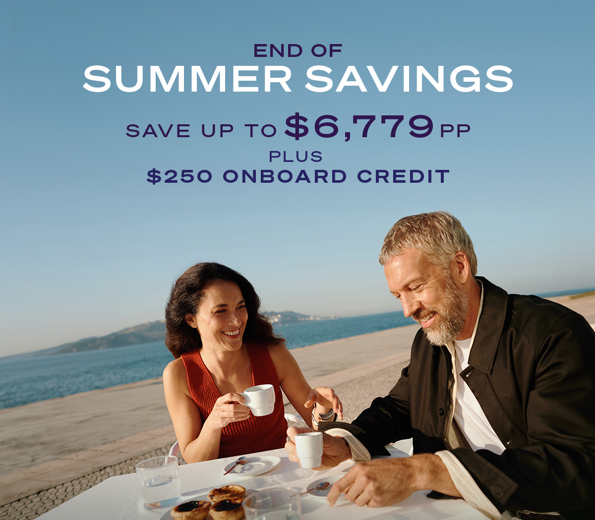 END OF SUMMER SAVINGS SAVING UP TO $6,779PP PLUS $250 ONBOARD CREDIT | A man and a woman having coffee and pastries at a seaside restaurant