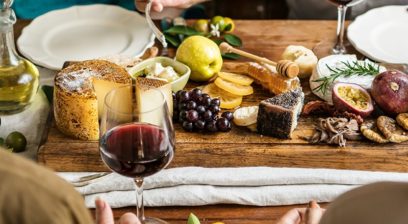 A table set with cheese, grapes, and array of Greek delicacies for an olive oil tasting