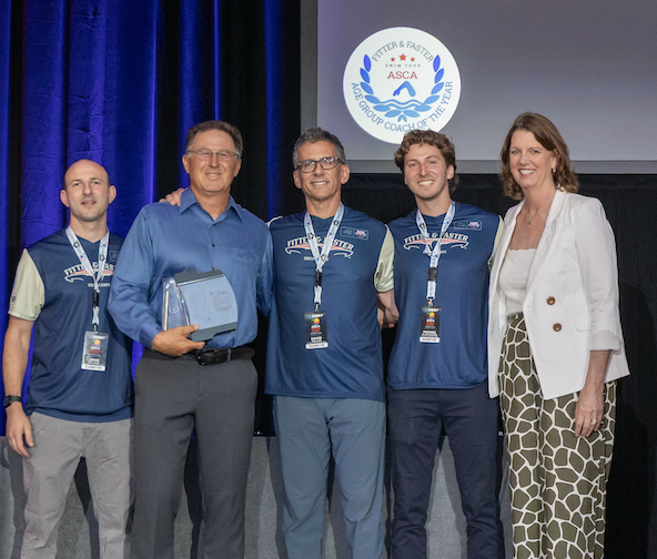 Brian Pajer receiving the 2026 Large Team Age Group Coach of the Year Award