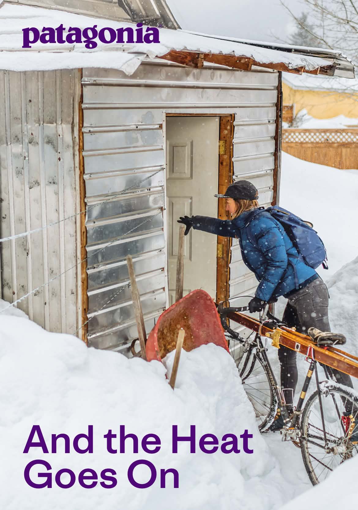 Patagonia. A person opens a door to a house while walking a bicycle with skis attached to it.