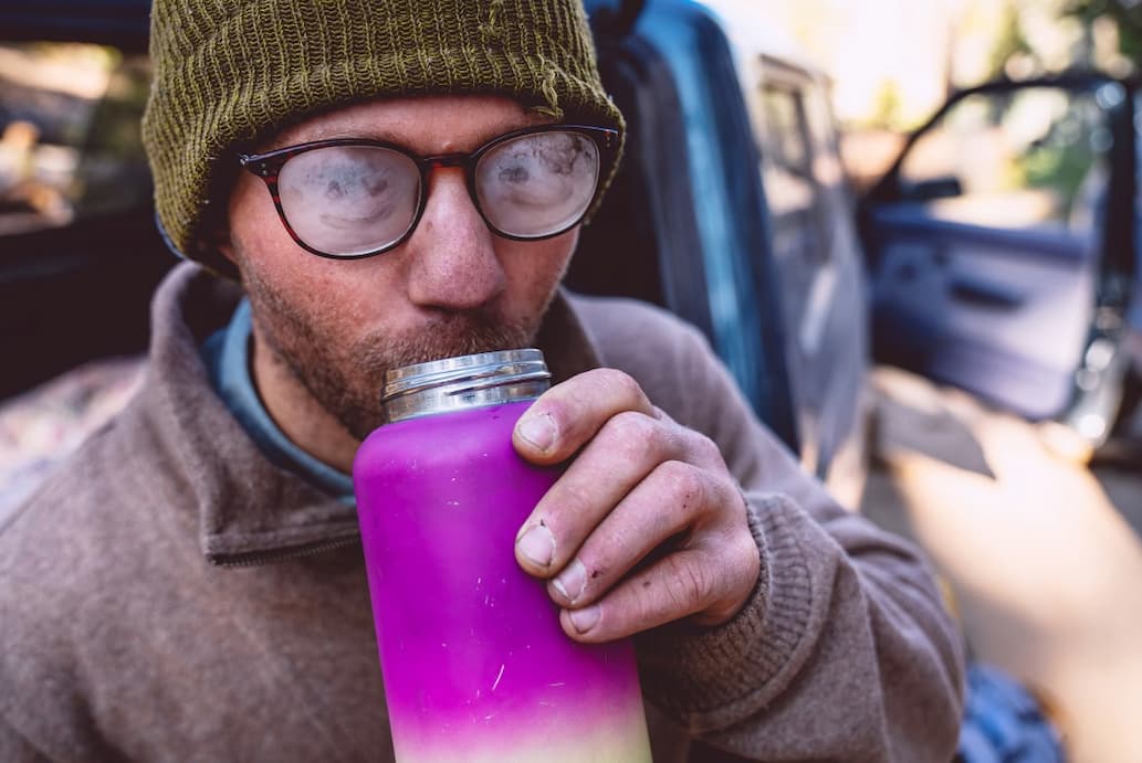 Patagonia. Sweaters for Going Full Steam. A person's glasses are fogged up from sipping a hot drink.