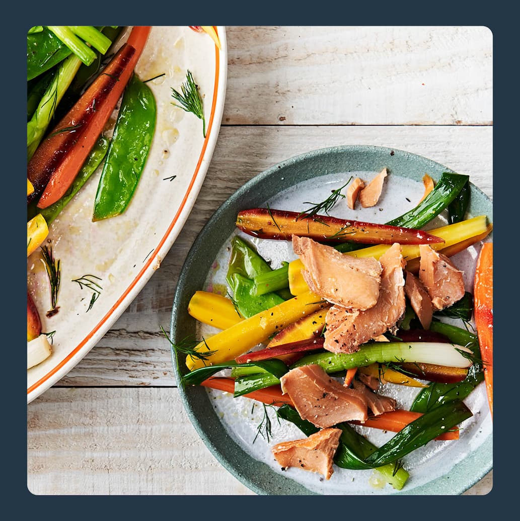A plate of smoked salmon and vegetables