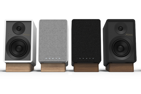 Two pairs on GX-30ARC powered monitors, in black and white finishes, with and without grilles, on a white background.