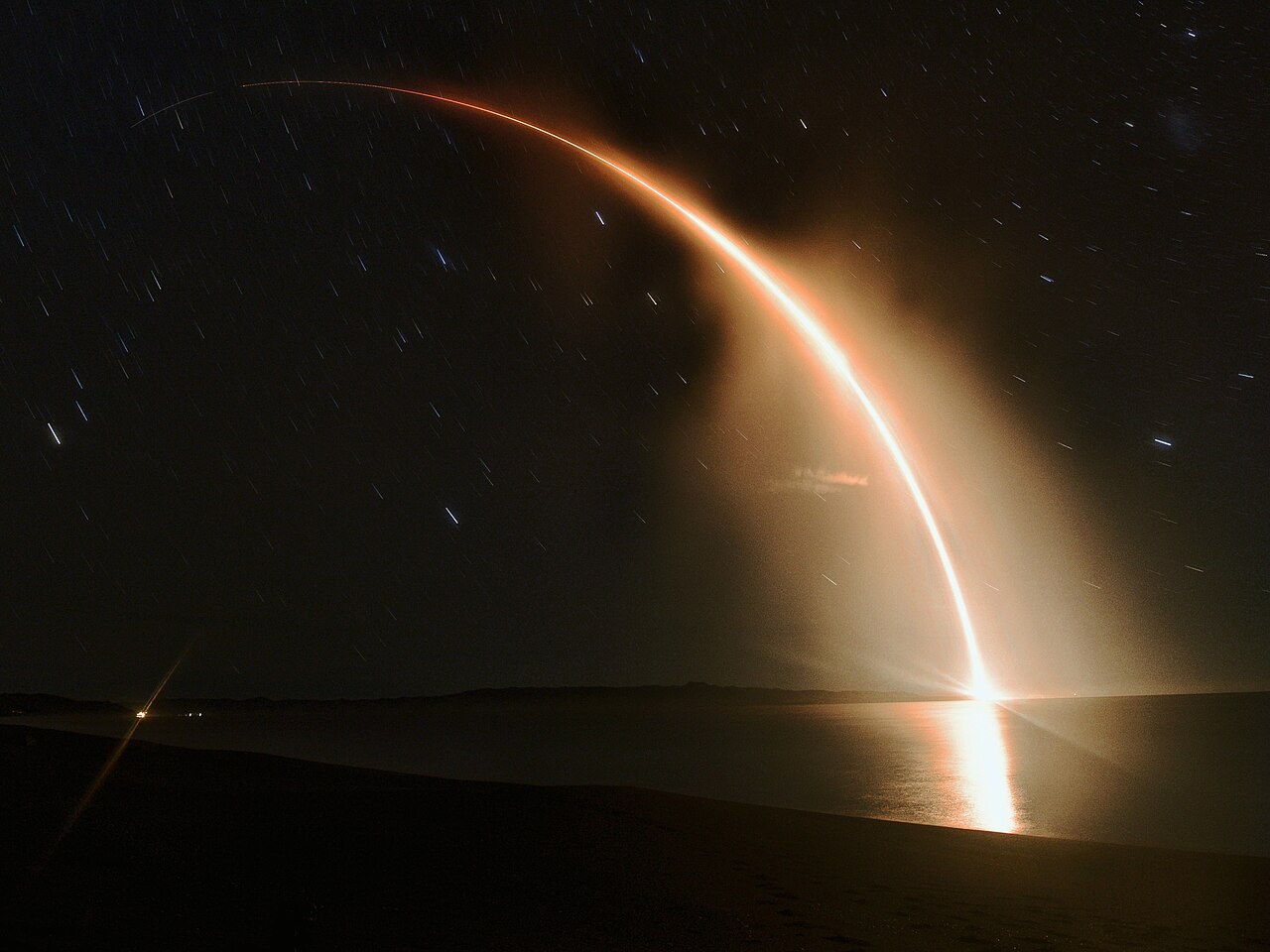 An Electron rocket launching at night