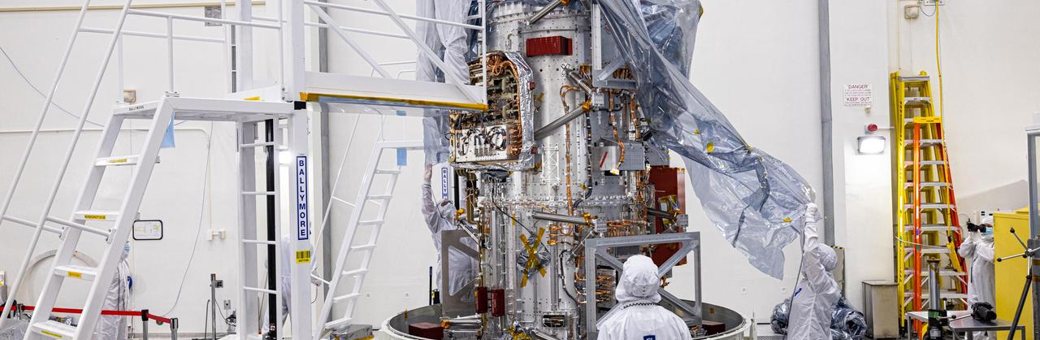 Technicians building a spacecraft in a clean room