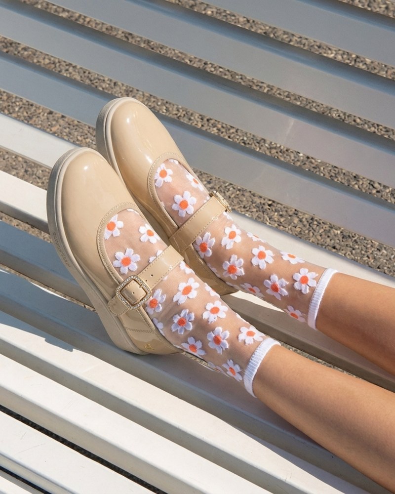Dream Mary Jane in Nude Patent, worn with sheer daisy socks.