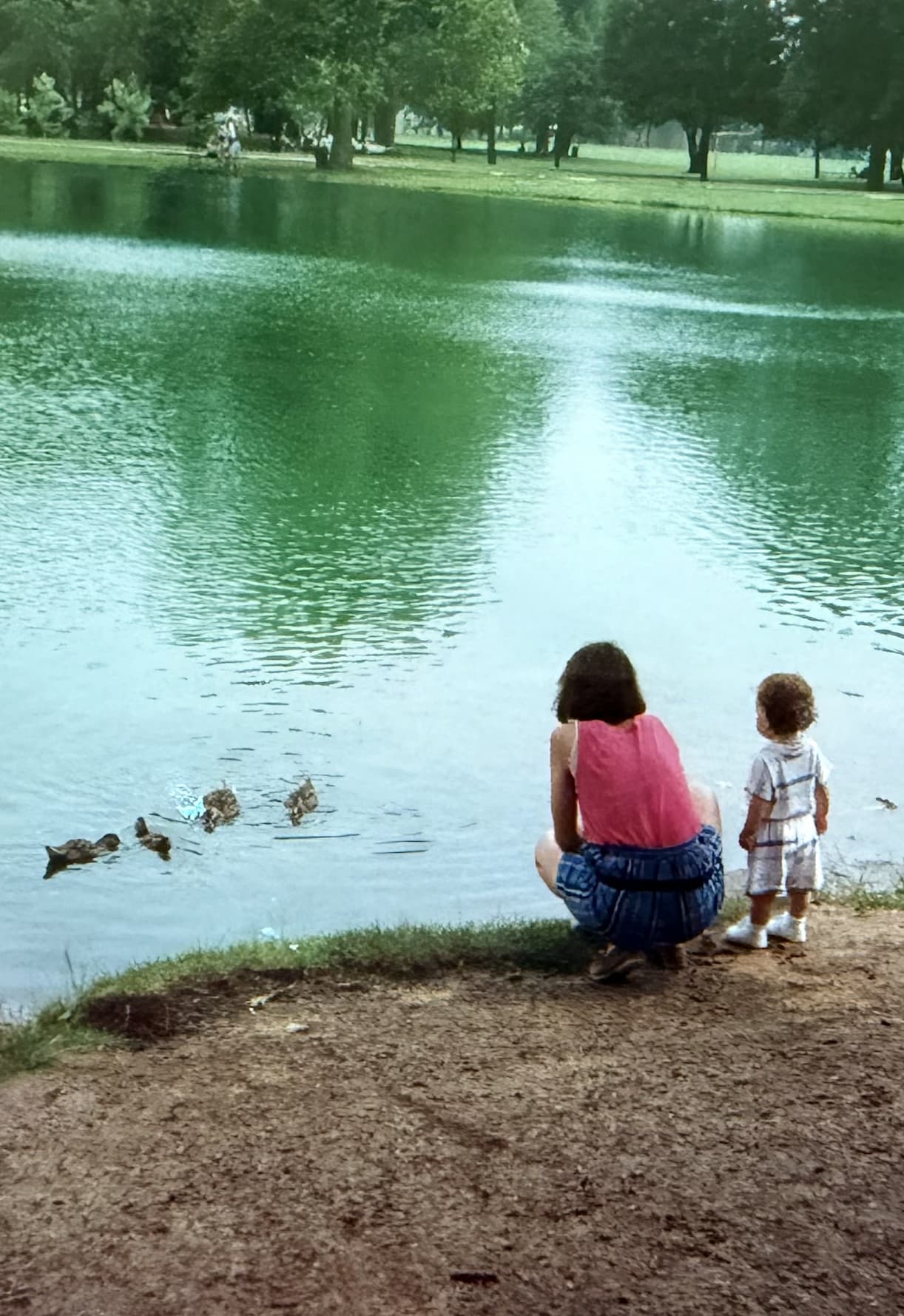 Mom and daughter by a pond