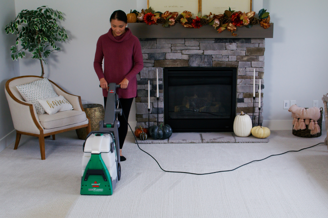 Cleaning carpet with a BISSELL Big Green carpet cleaner rental
