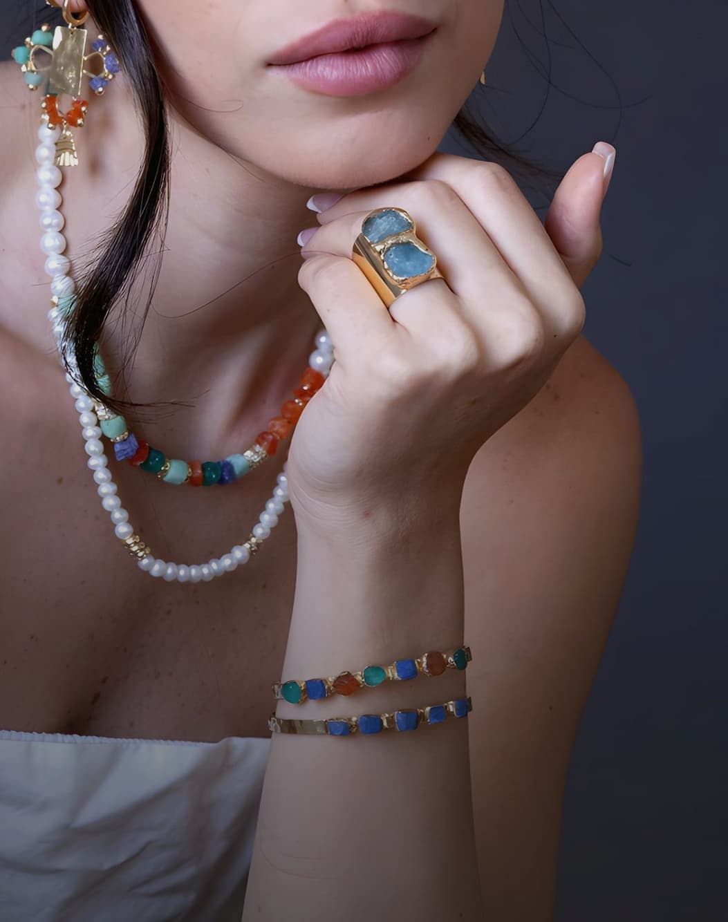 Handmade gemstone jewelry and pearls, worn together.