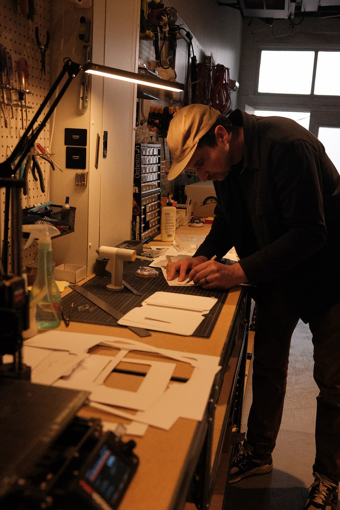an image of a man working on a piece of paper in a workshop
