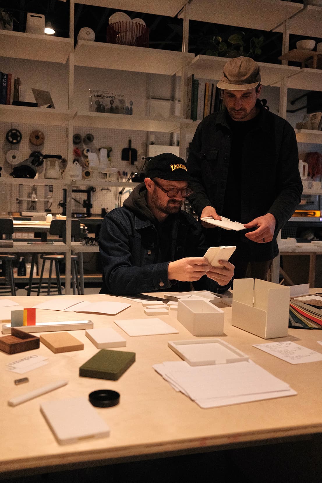 an image of two men are working on a project in a workshop