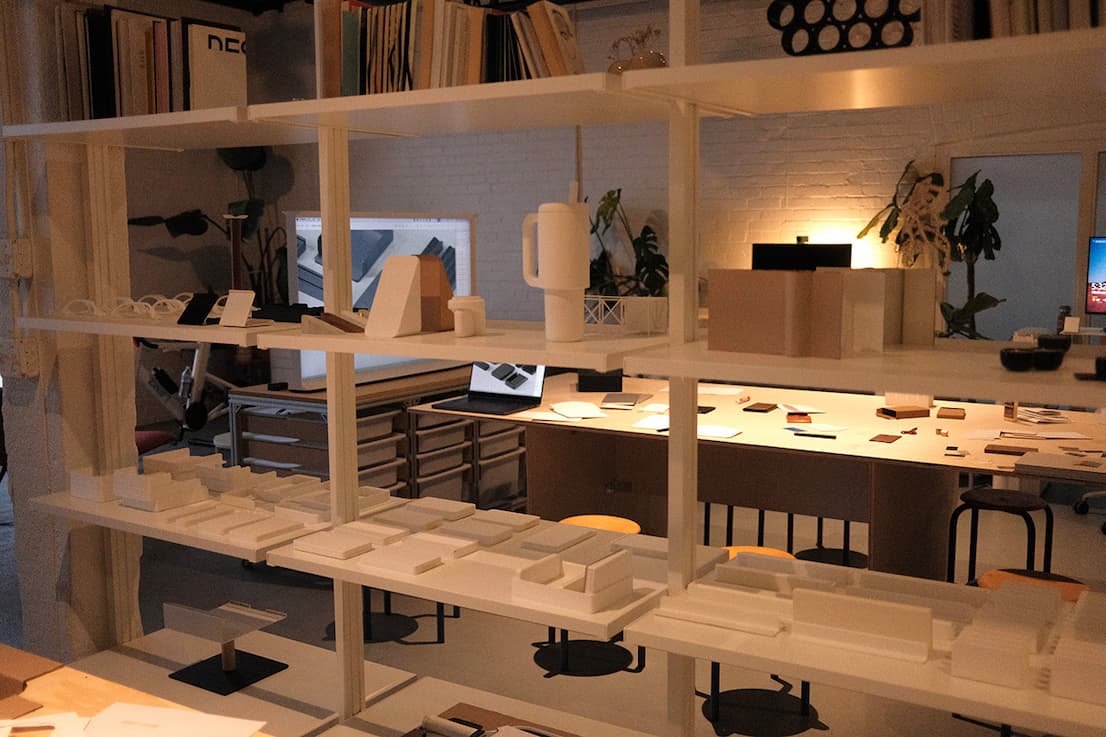 an image of a room with a desk and shelves with various items