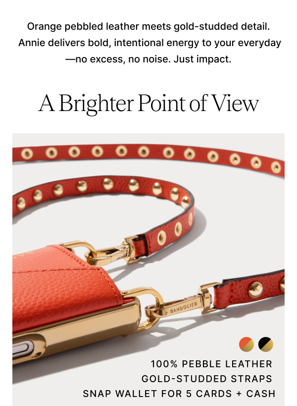 Orange pebbled leather meets gold-studded detail.  Annie delivers bold, intentional energy to your everyday—no excess, no noise. Just impact. A Brighter Point of View 100% PEBBLE LEATHER GOLD-STUDDED STRAPS SNAP WALLET FOR 5 CARDS + CASH