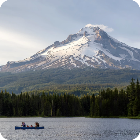 People canoeing on a lake near the base of Mt. Hood.