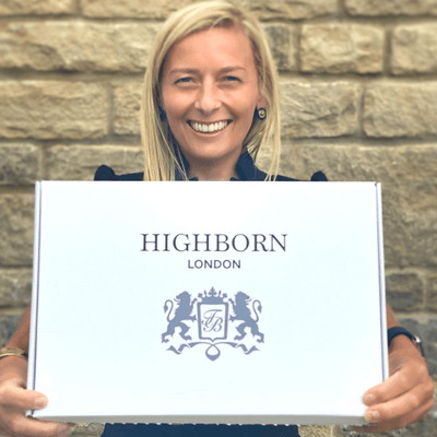 Tracey Broadway, founder of HIGHBORN, holding a HIGHBORN box